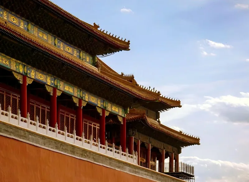 The red and gold facade of a palace hall, bracket sets and lattice doors in close detail