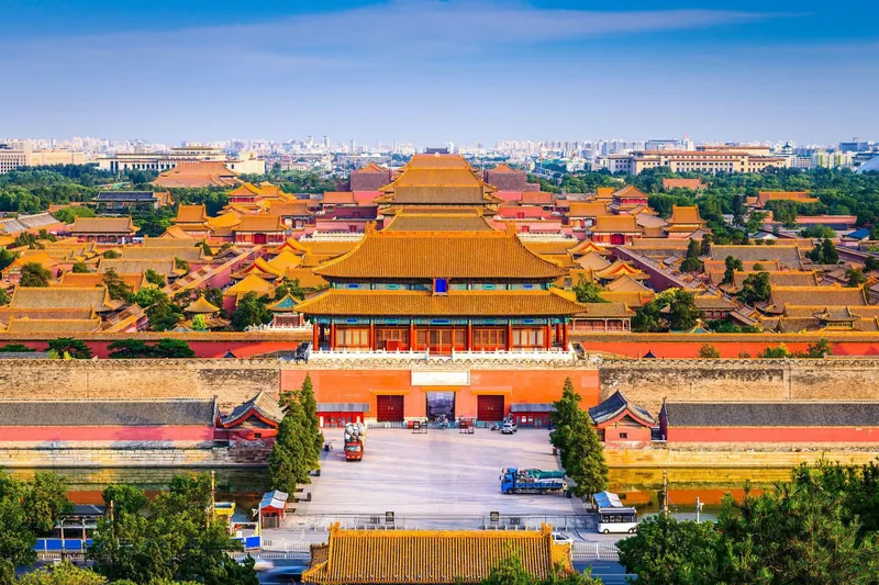 The golden roofscape of the palace seen from above, ridges receding into the haze