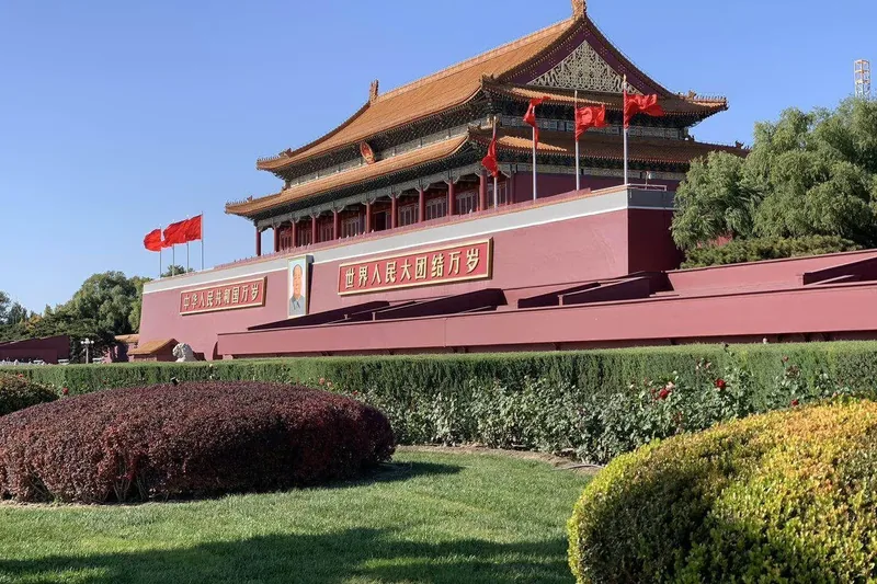 Tiananmen Gate with its portrait and flanking flags, seen from the park side